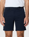 Model wearing 7 Navy Classic Twill Shorts with side pockets.