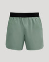 7 Juniper Active Training Shorts 2.0, sage-green with black waistband, mid-thigh.