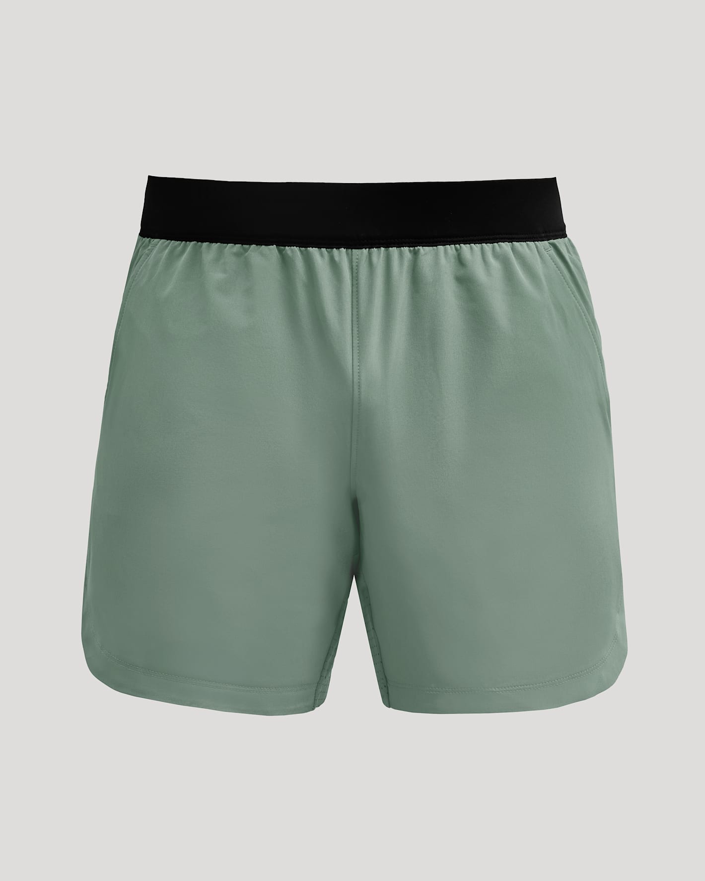 7 Juniper Active Training Shorts 2.0, sage-green with black waistband, mid-thigh.