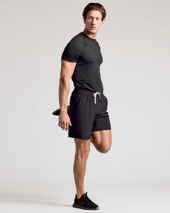 True ClassicMan stretching in 9 All Black Active Quick Dry Shorts.