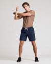 Man stretching in Navy 9 Active Quick Dry Shorts.