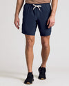 Man wearing Navy 9 Active Quick Dry Shorts with black sneakers.
