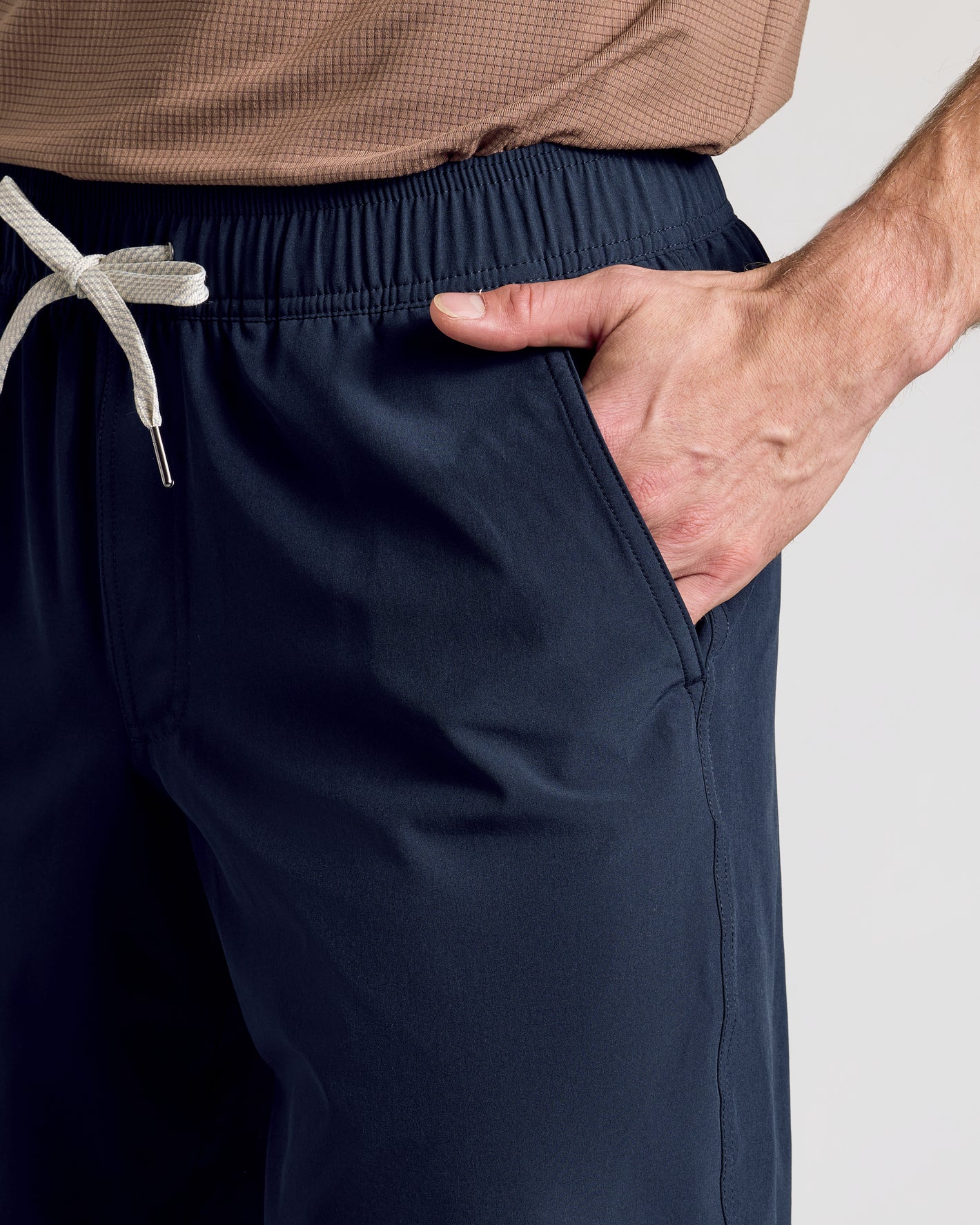 Person wearing Navy 9 Active Quick Dry Shorts with elastic waistband and drawcord.