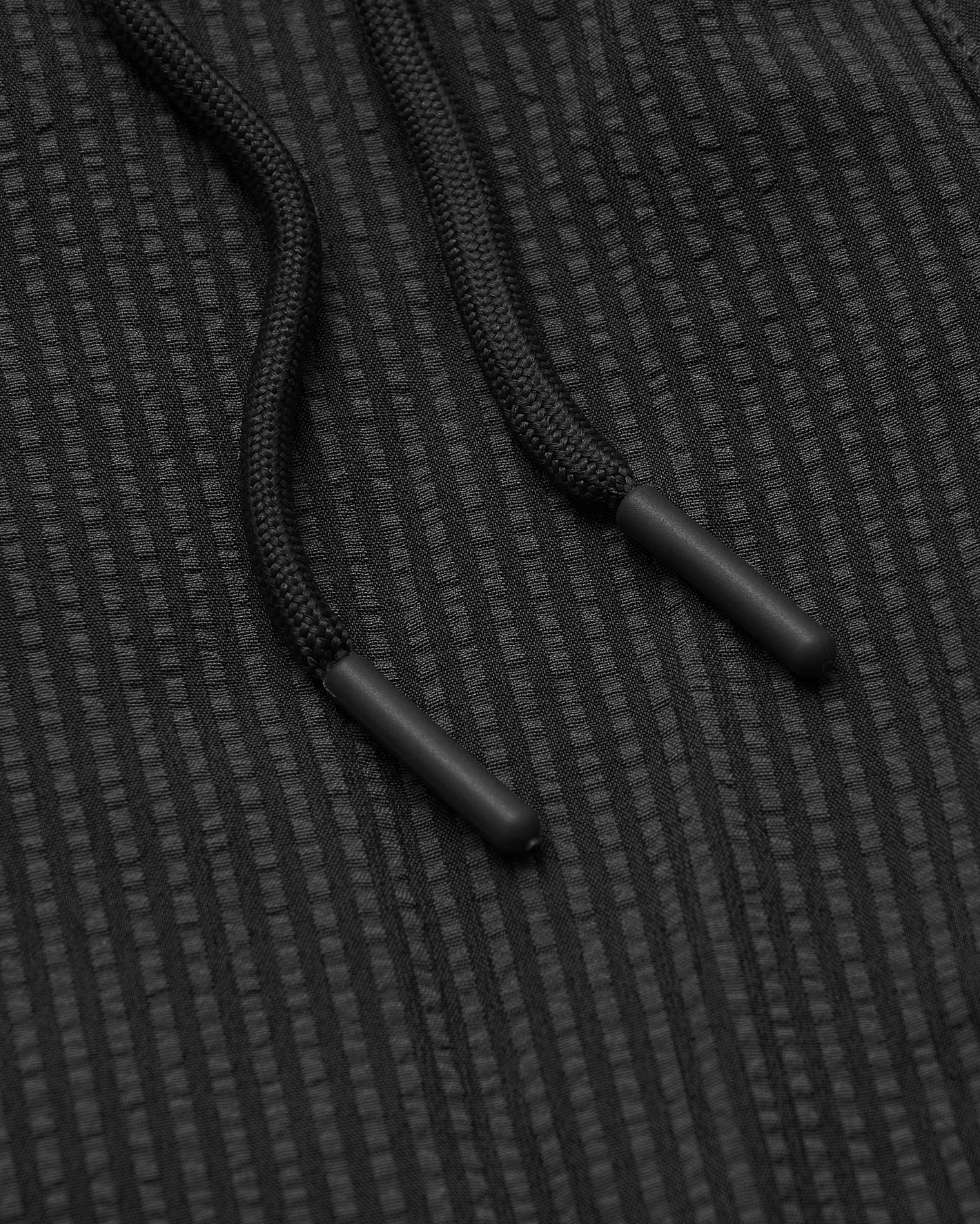 7 Smoke Seersucker Swim Trunks' black braided drawcords with matte aglets.