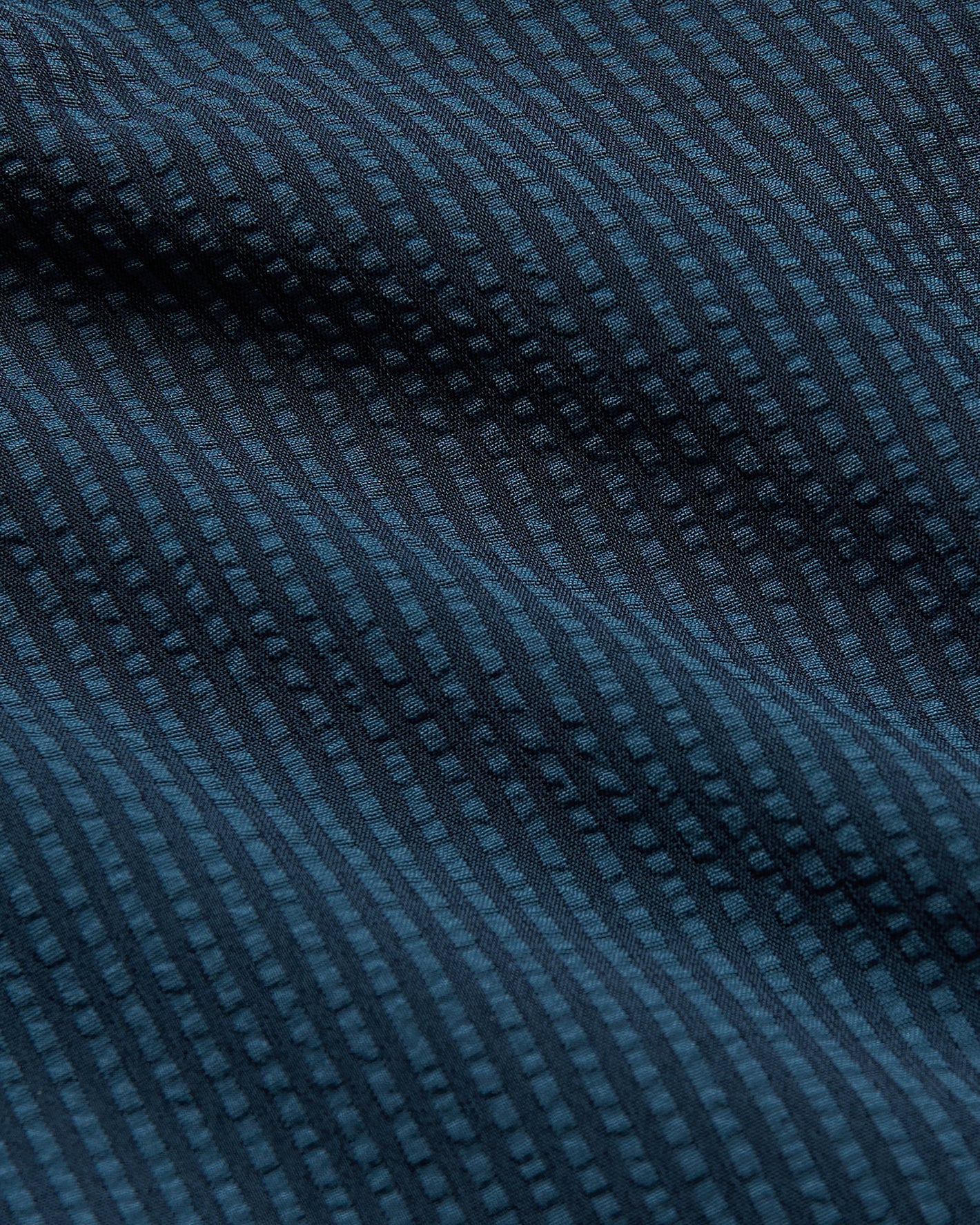 7 Seersucker Trunks with dark-blue woven texture, vertical raised-dot pattern.