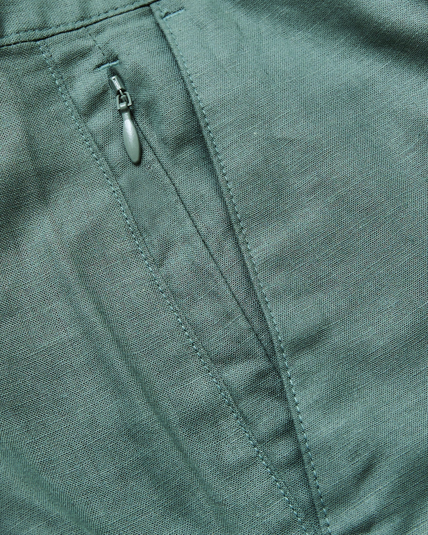 7 Moss Linen Shorts pocket detail with zipper and seam.