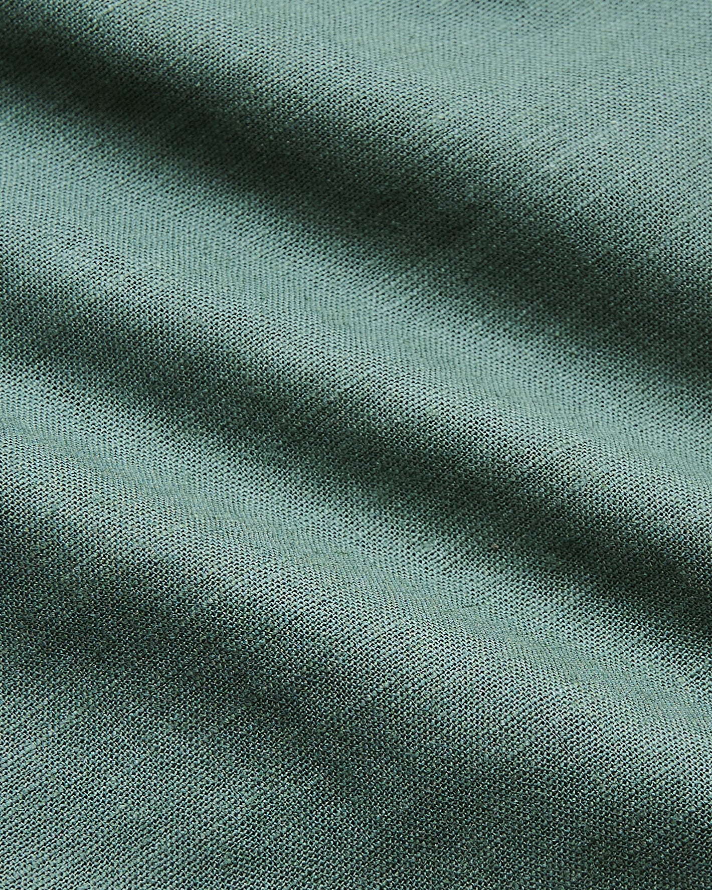 7 Moss Linen Shorts with soft teal knit fabric texture.