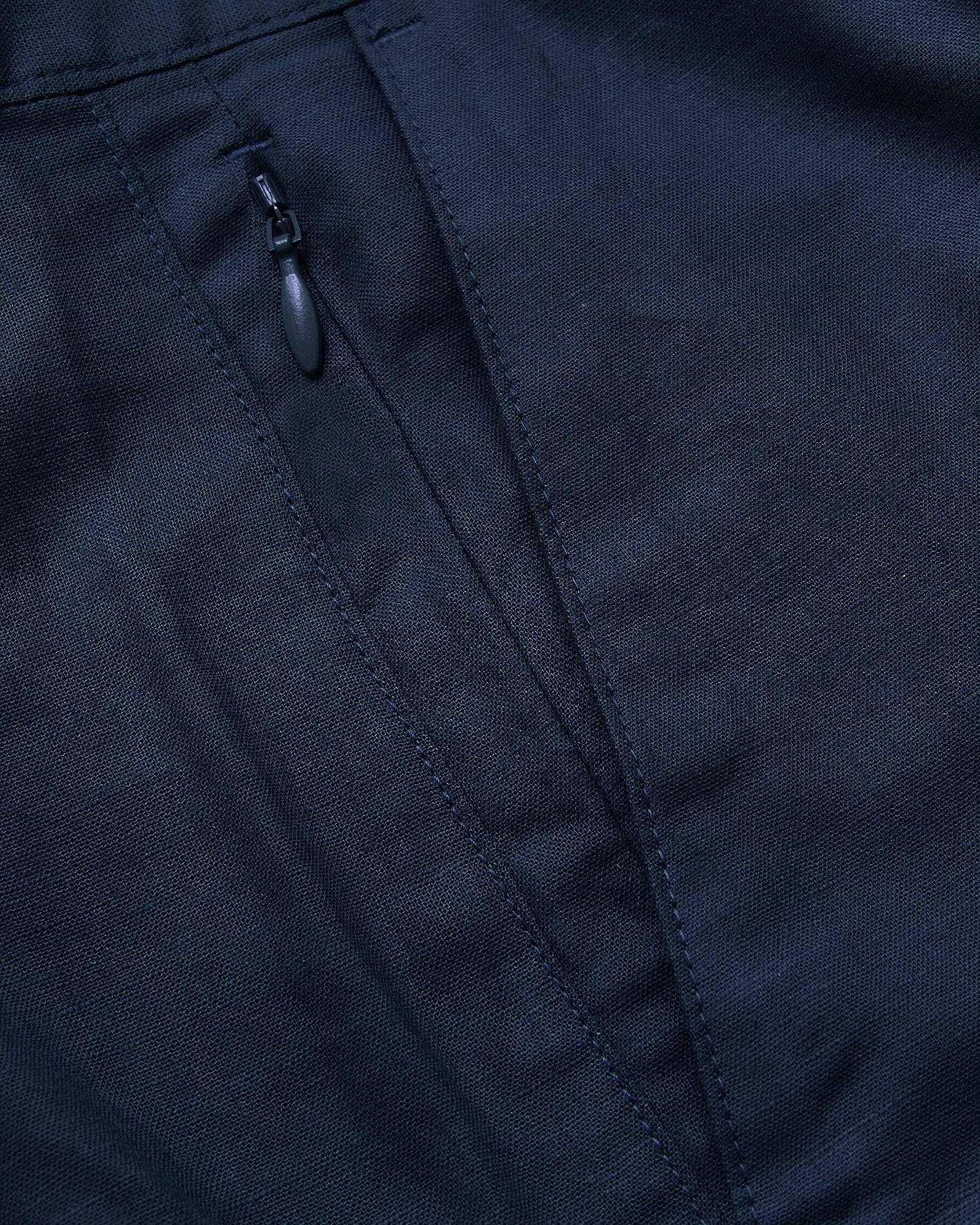 7 Navy Linen Shorts with woven texture and zippered pocket detail.