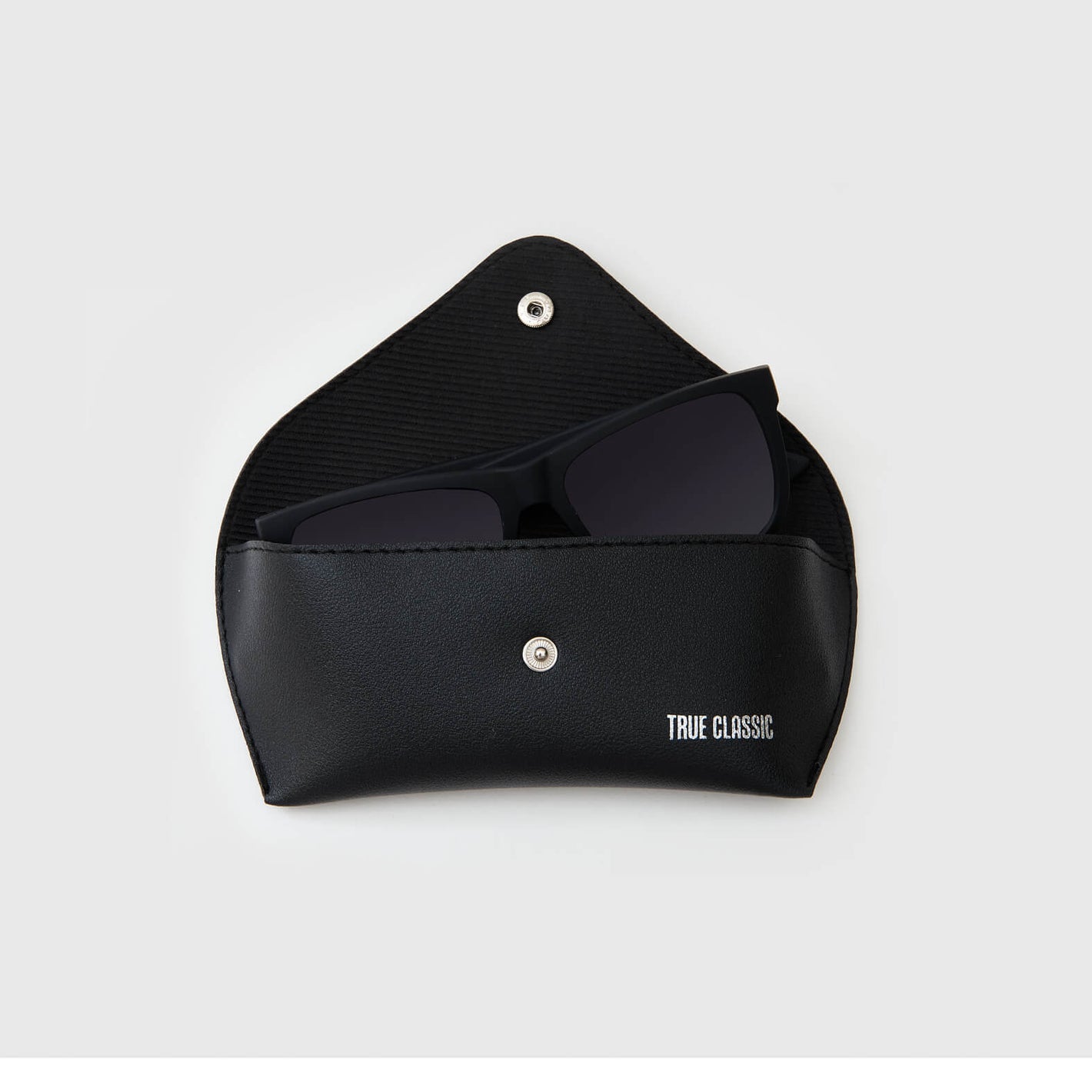 Copy Of Classic Polarized Sunglasses in open black pouch, revealing tinted lenses.