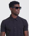 Classic Polarized Sunglasses on Black man looking right, light background.