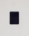 Black Classic Wallet: Slim black vegan leather card-holder with embossed TRUE CLASSIC.