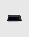 Black Classic Wallet on gray surface, showcasing card slots with cards.