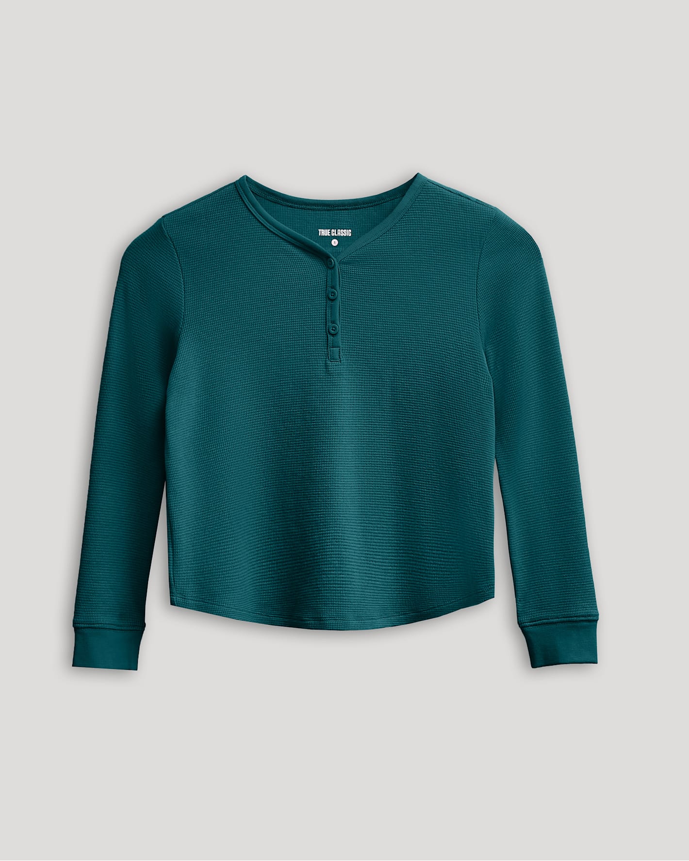 Girls Deep Emerald Long Sleeve Boxy Waffle Henley with buttoned neckline.