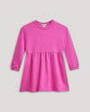 Girls Electric Fuchsia Long Sleeve Fleece Dress with peplum waist and elastic cuffs.