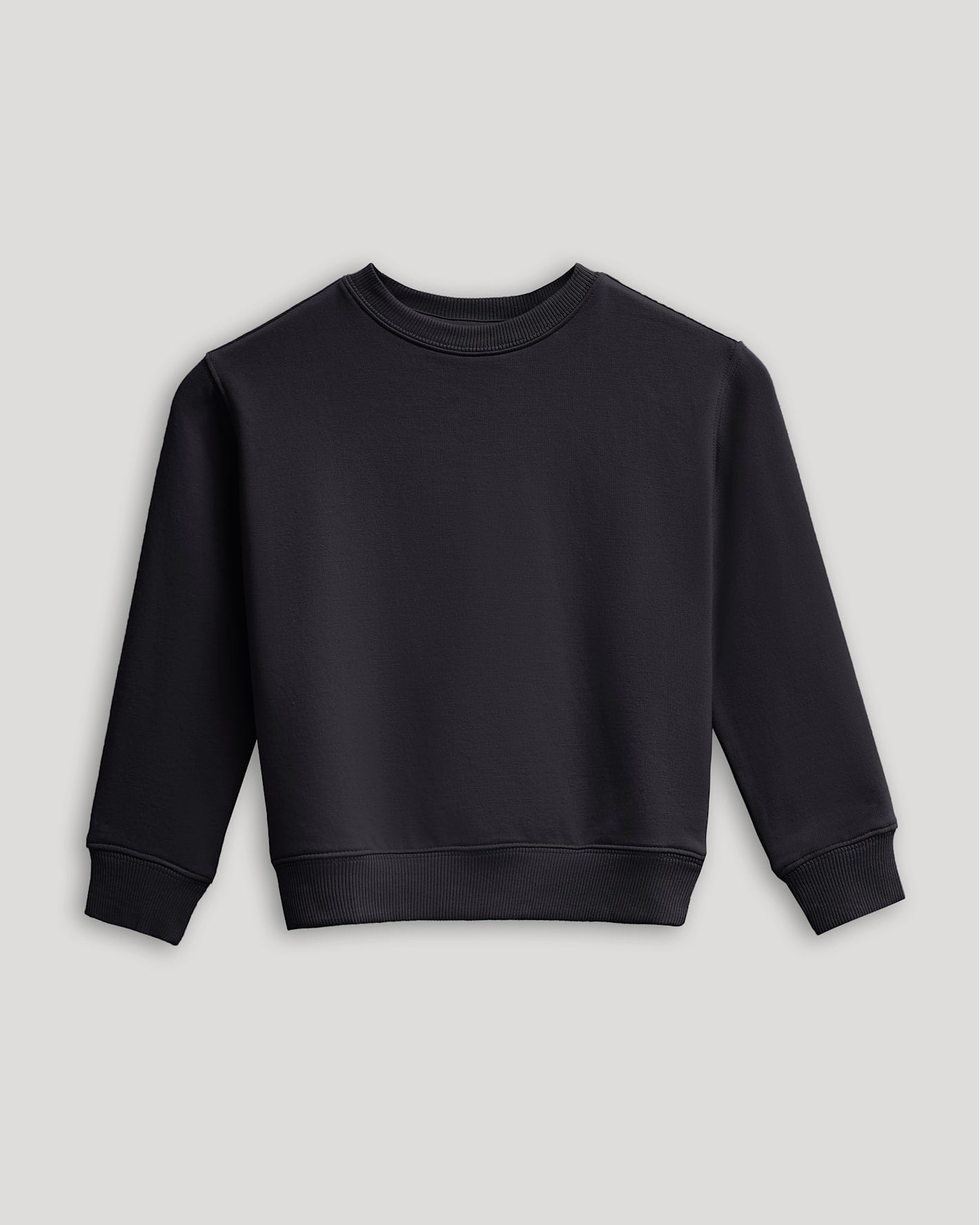 Girls Black Slouch Pullover Crew, laid flat, highlighting its relaxed fit.