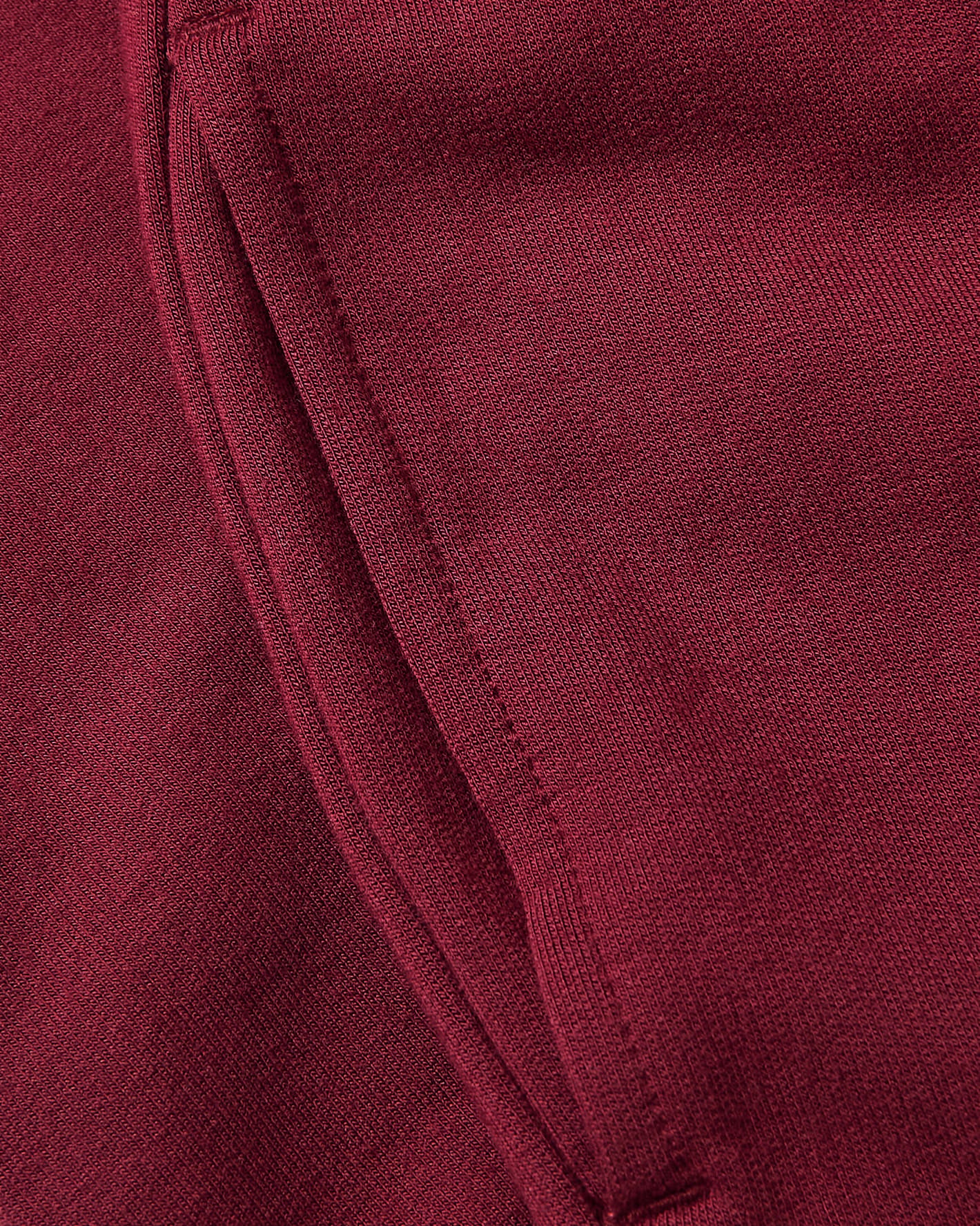 Girls Dark Maroon Cropped Zip Hoodie pocket detail with stitched edge.