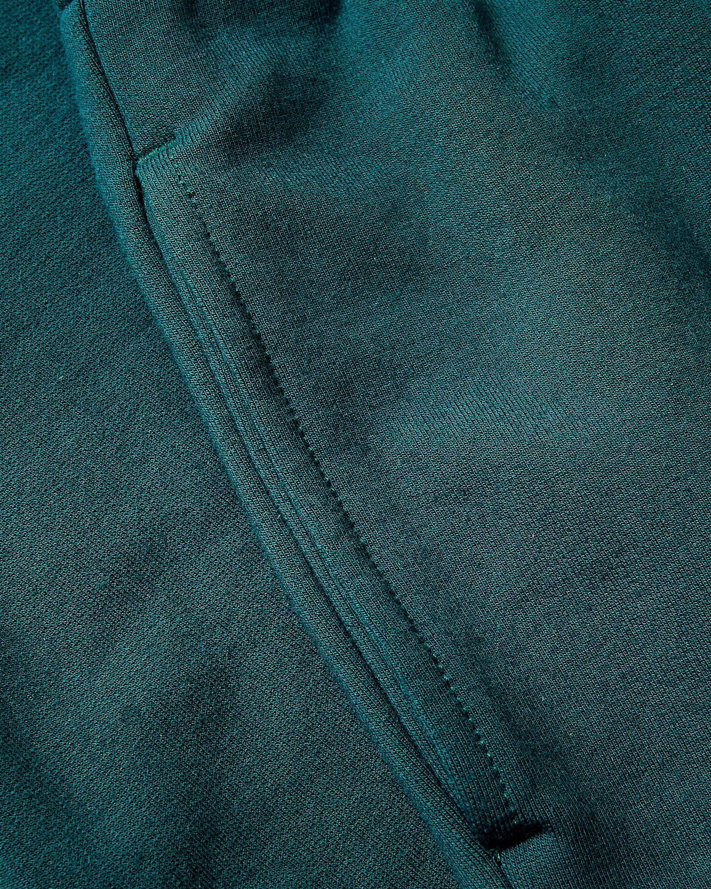 Girls Deep Emerald Cropped Zip Hoodie seam detail on knit fabric.