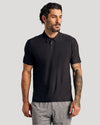 Man modeling Black Active Polo, showcasing its fitted style and comfort features.