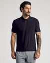 Model wearing Active Polo 6-Pack in black with tattooed arm.