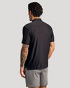 Man in Black Active Polo 3-Pack, showing back and tattooed arm.