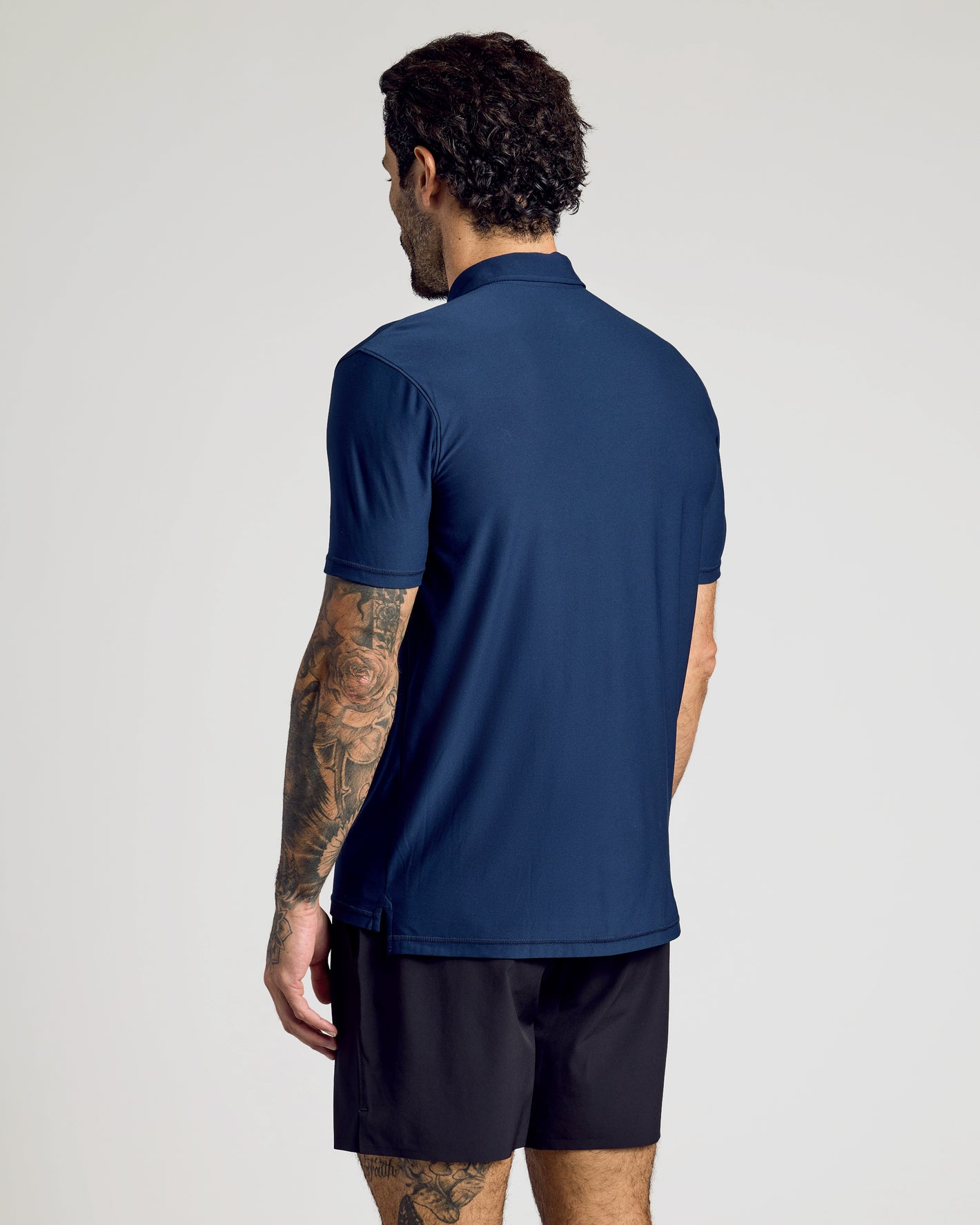 Rear view of man in navy Active Polo 10-Pack shirt.