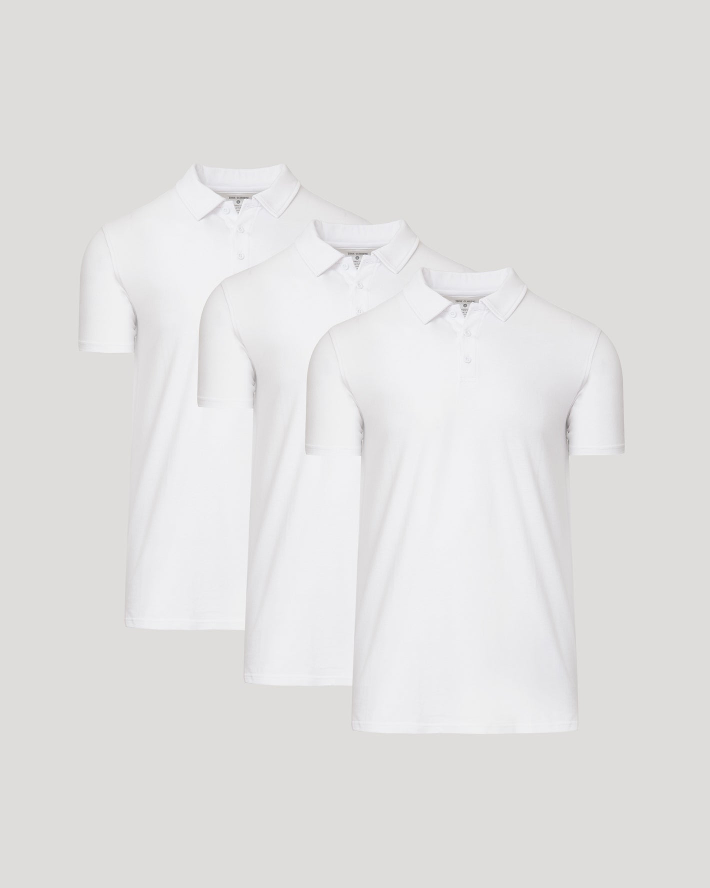 All White Tall Classic Polo 3-Pack: Three neatly arranged white polo shirts.