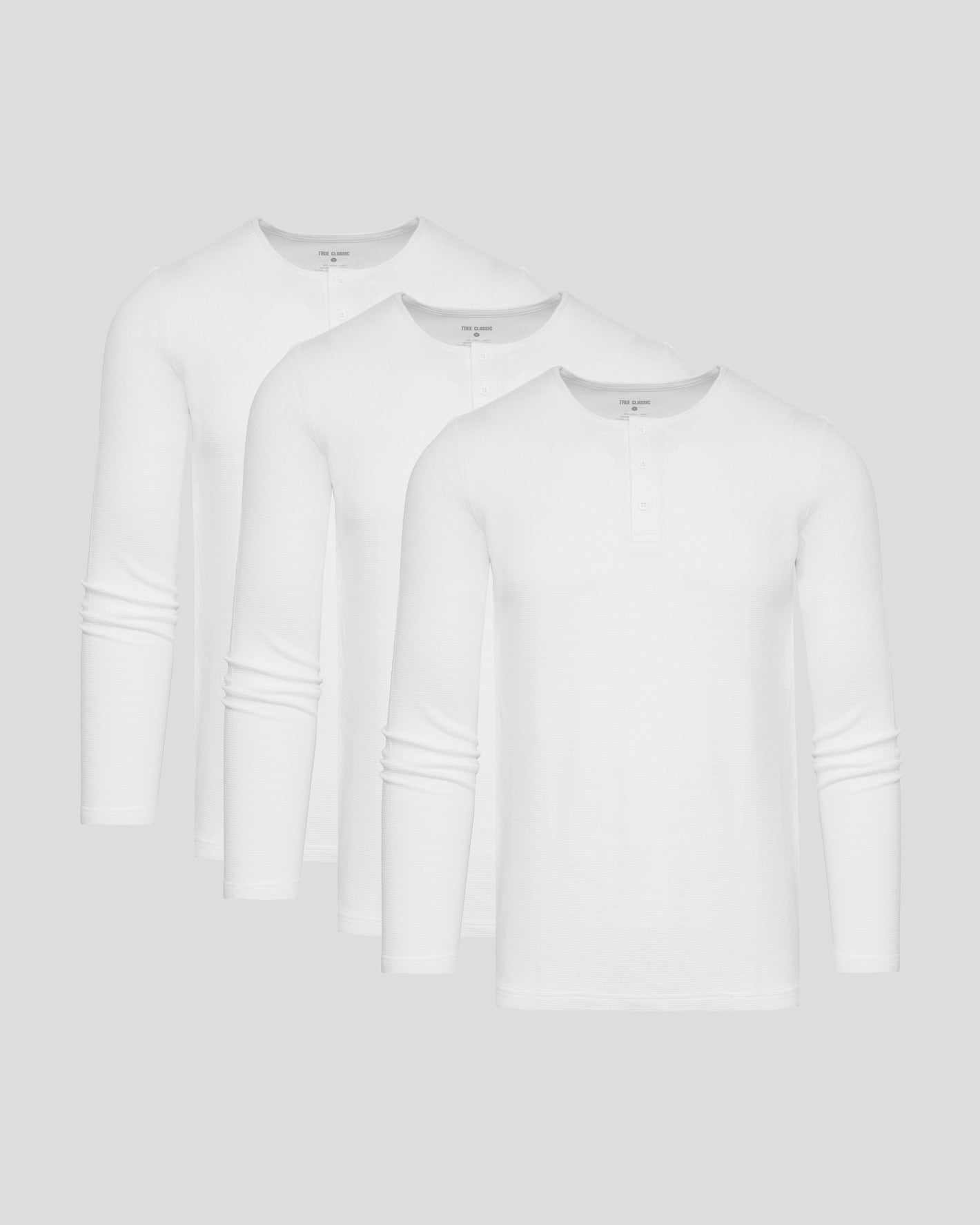 White Waffle Long Sleeve Henley 3-Pack with textured, buttoned, round necklines.