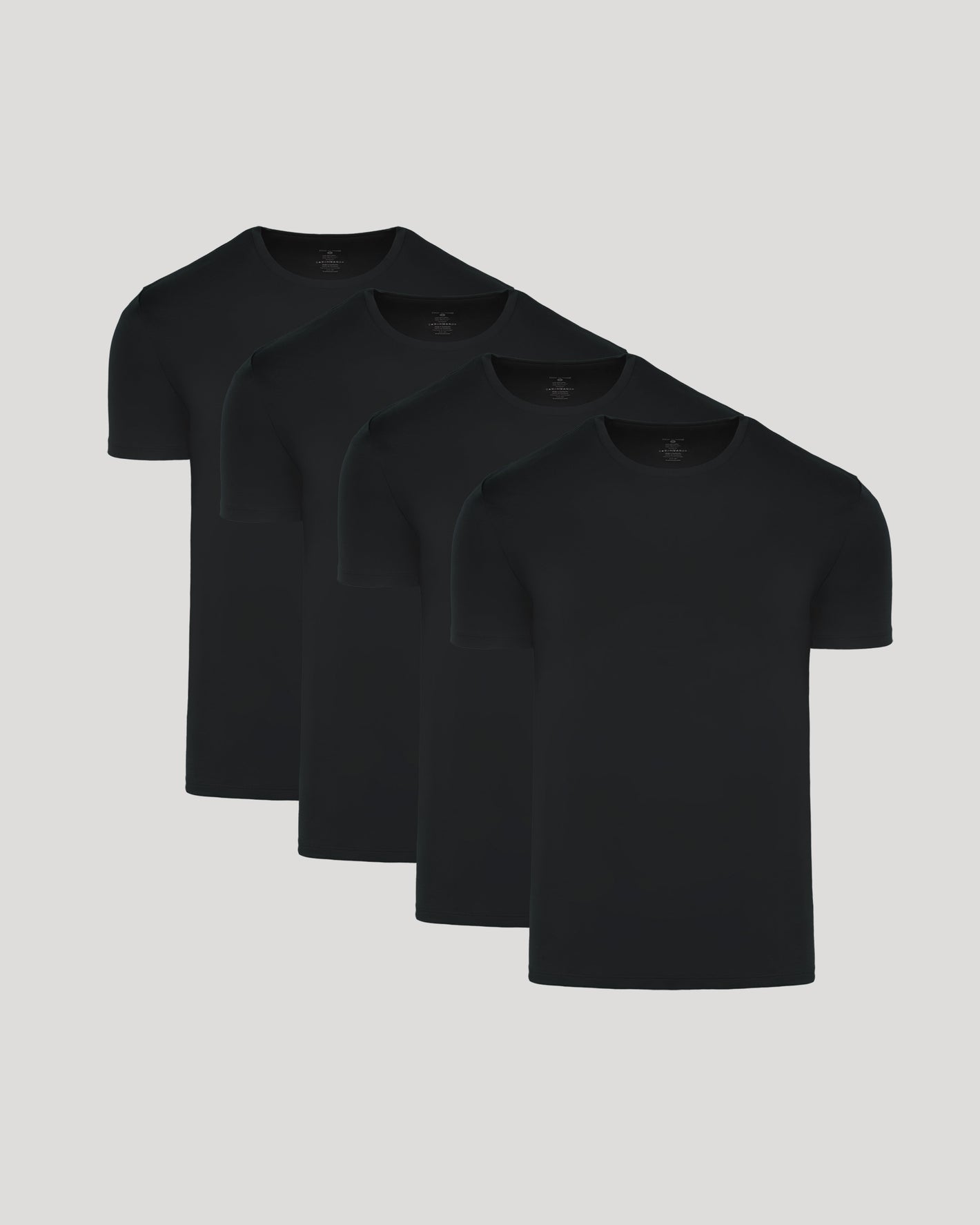 Black Premium Pima Crew Neck 4-Pack: plain black T-shirts, neatly staggered.