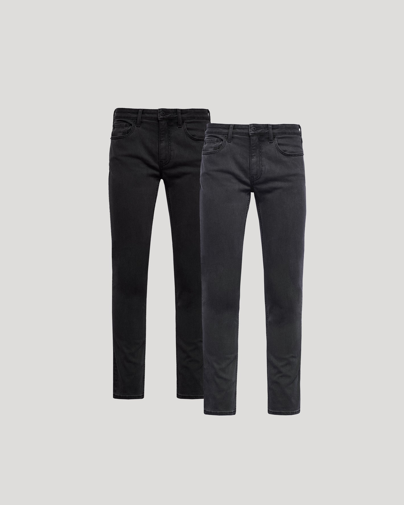 Two pairs of black jeans on a light gray background