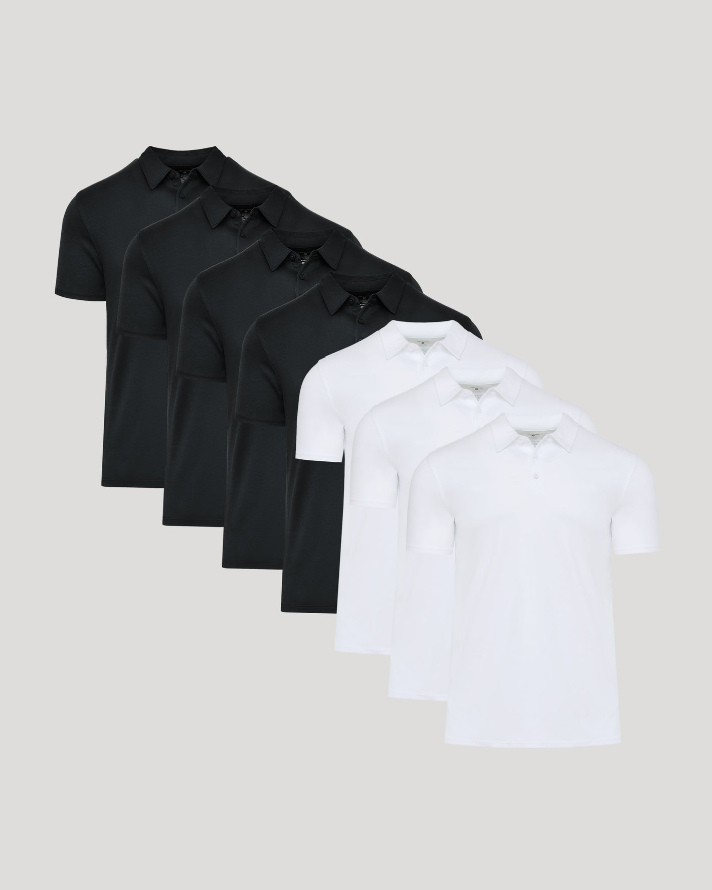 Black & White Premium Pima Polo 7-Pack neatly arranged on neutral background.