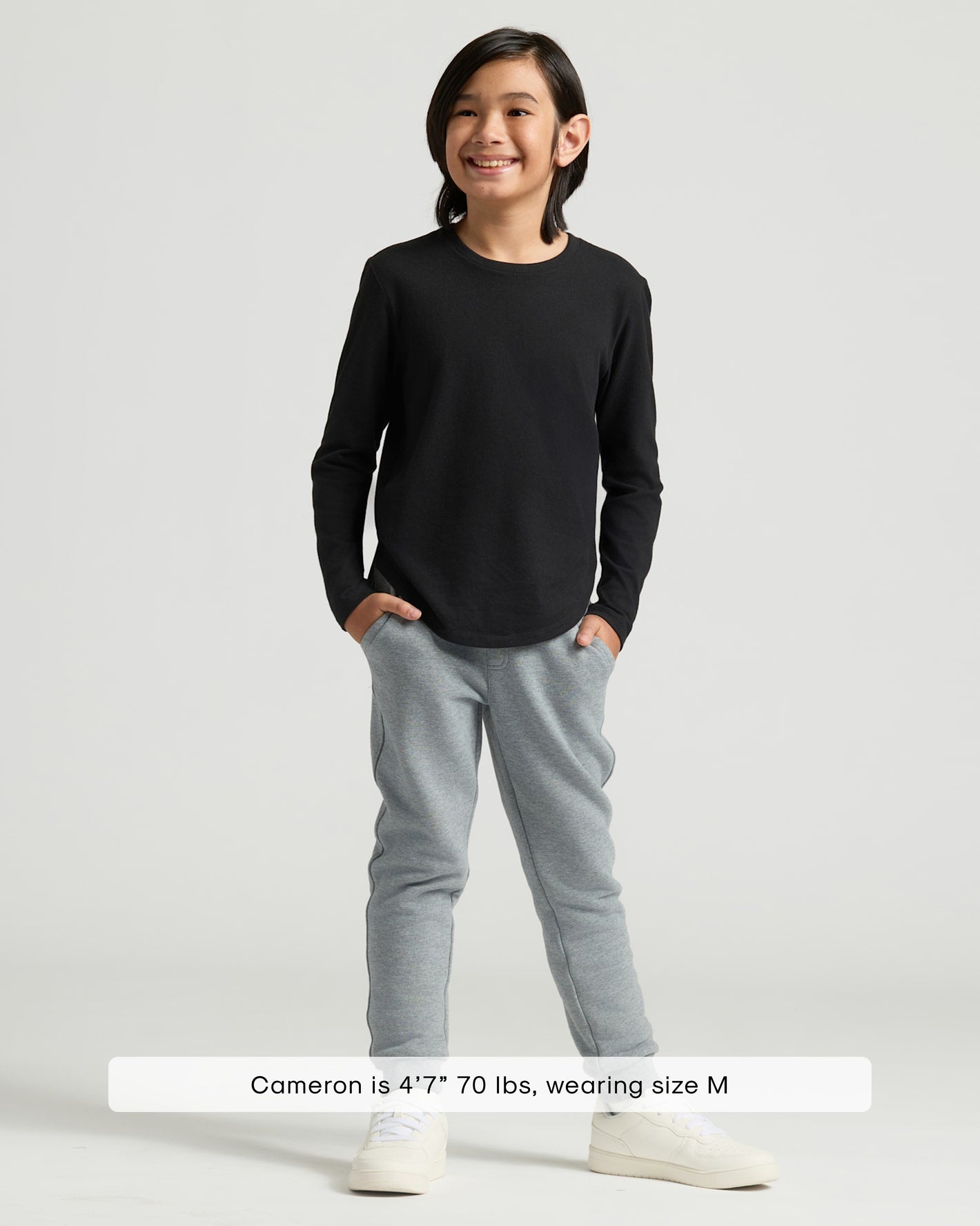 Boy wearing Boys' All Black Classic Long Sleeve Curved Hem Crew Neck.