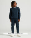 Boy wearing Boys' Black & Navy Fleece Joggers 2-Pack with sneakers.