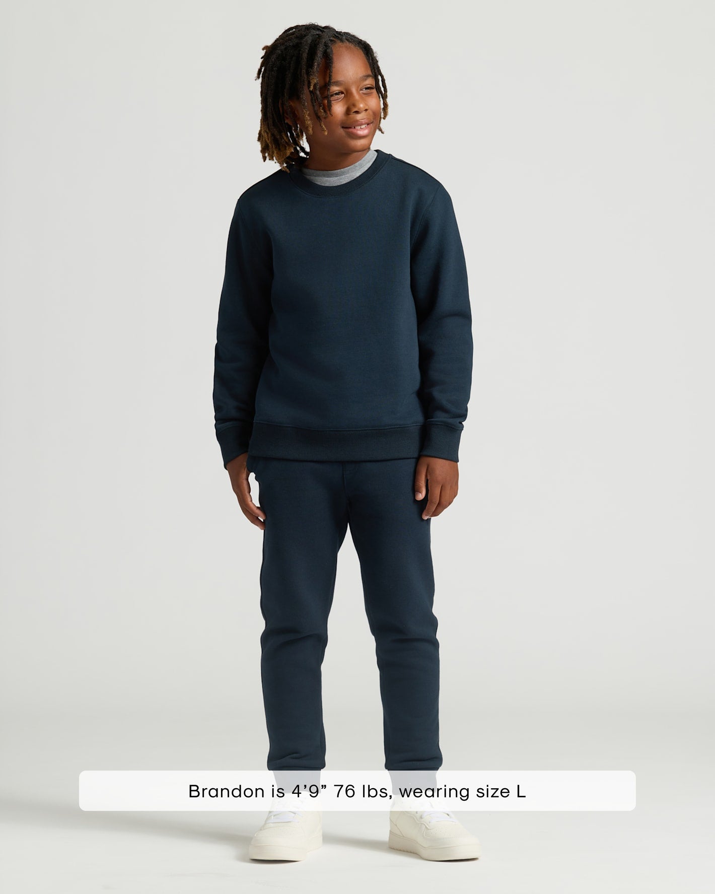 Boy wearing Boys' Black & Navy Fleece Joggers 2-Pack with sneakers.
