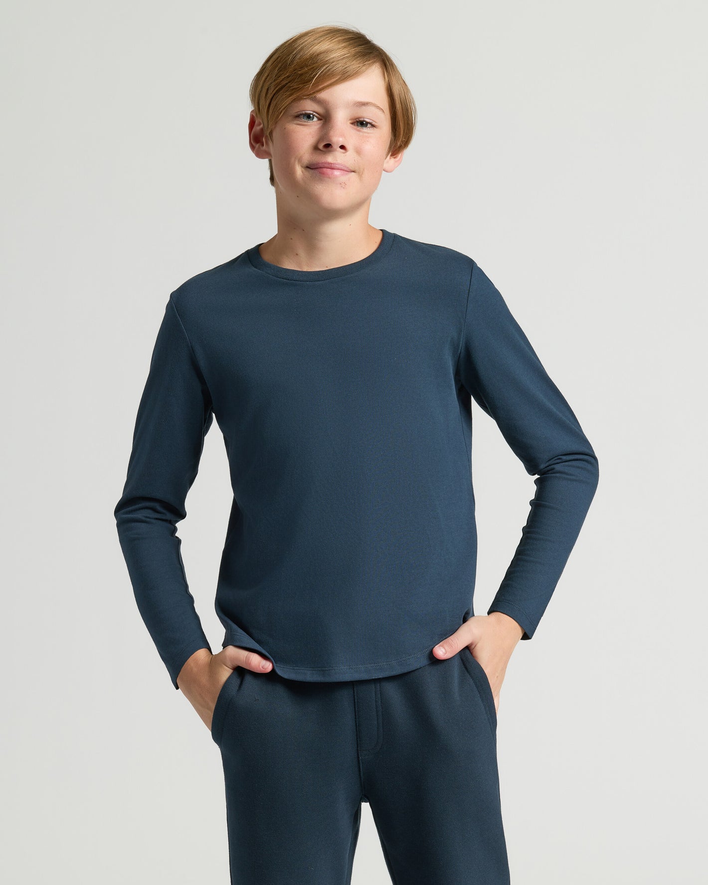 Teen boy in Boys' Classic Long Sleeve Curved Hem Crew Neck 3-Pack.
