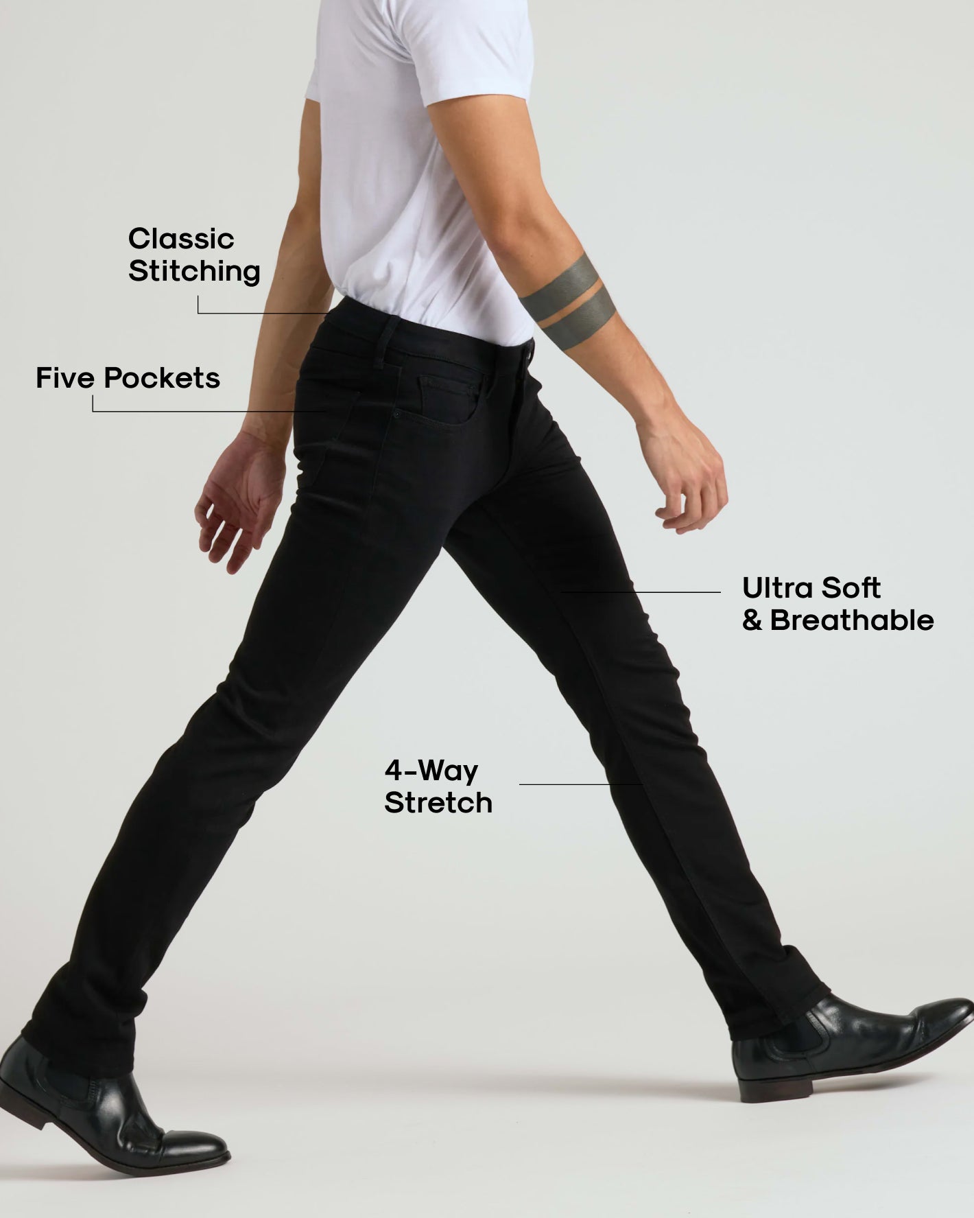 Wearing Black Wash Slim Comfort Stretch Jeans mid-stride, showing classic stitching.