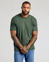 Man wearing CombinedListingTest Classic Crew Neck, arms by sides, tattooed forearms.