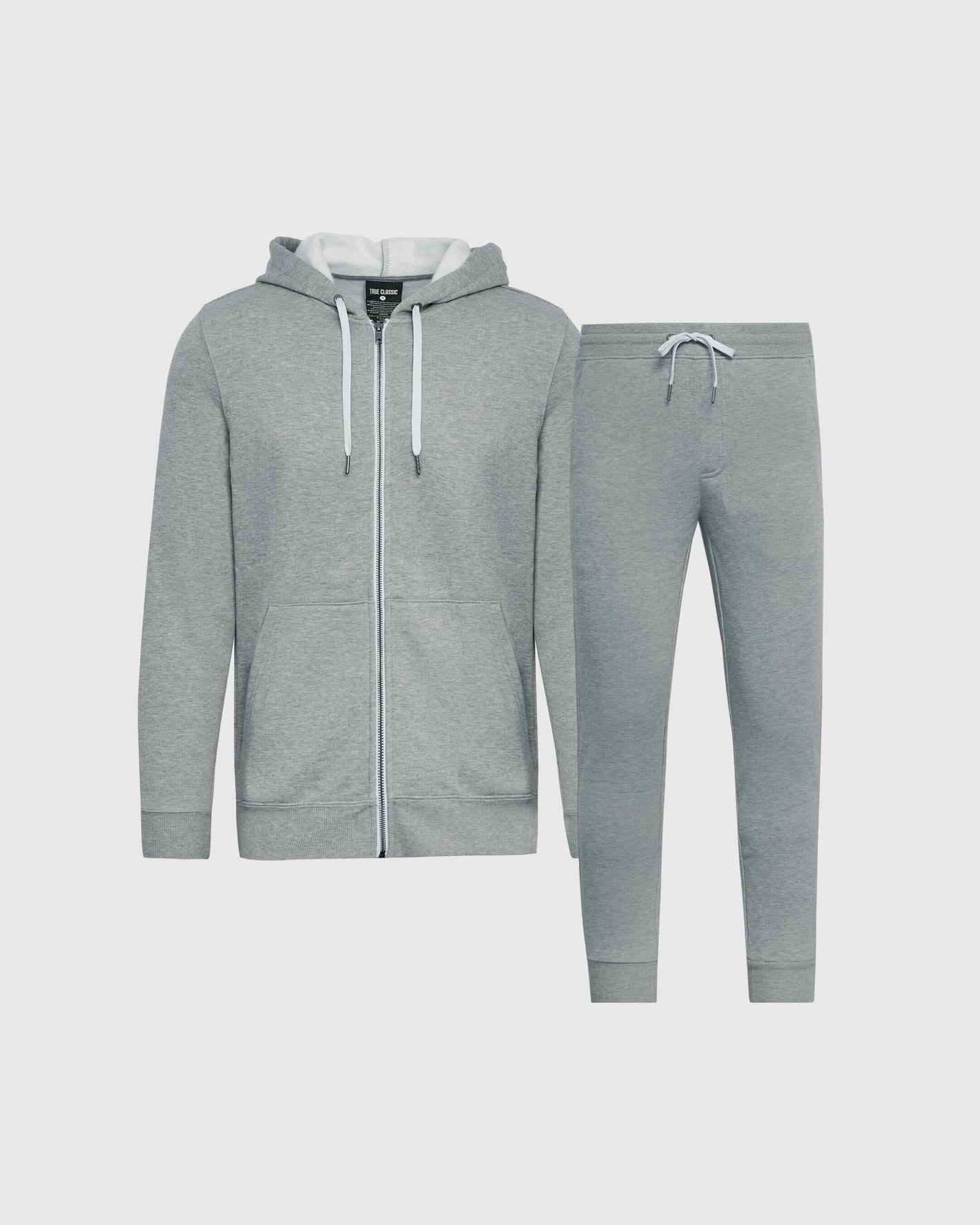 A two-piece gray fleece tracksuit set consisting of a zip-up hoodie with white drawstrings and matching jogger pants, displayed on a light gray background.