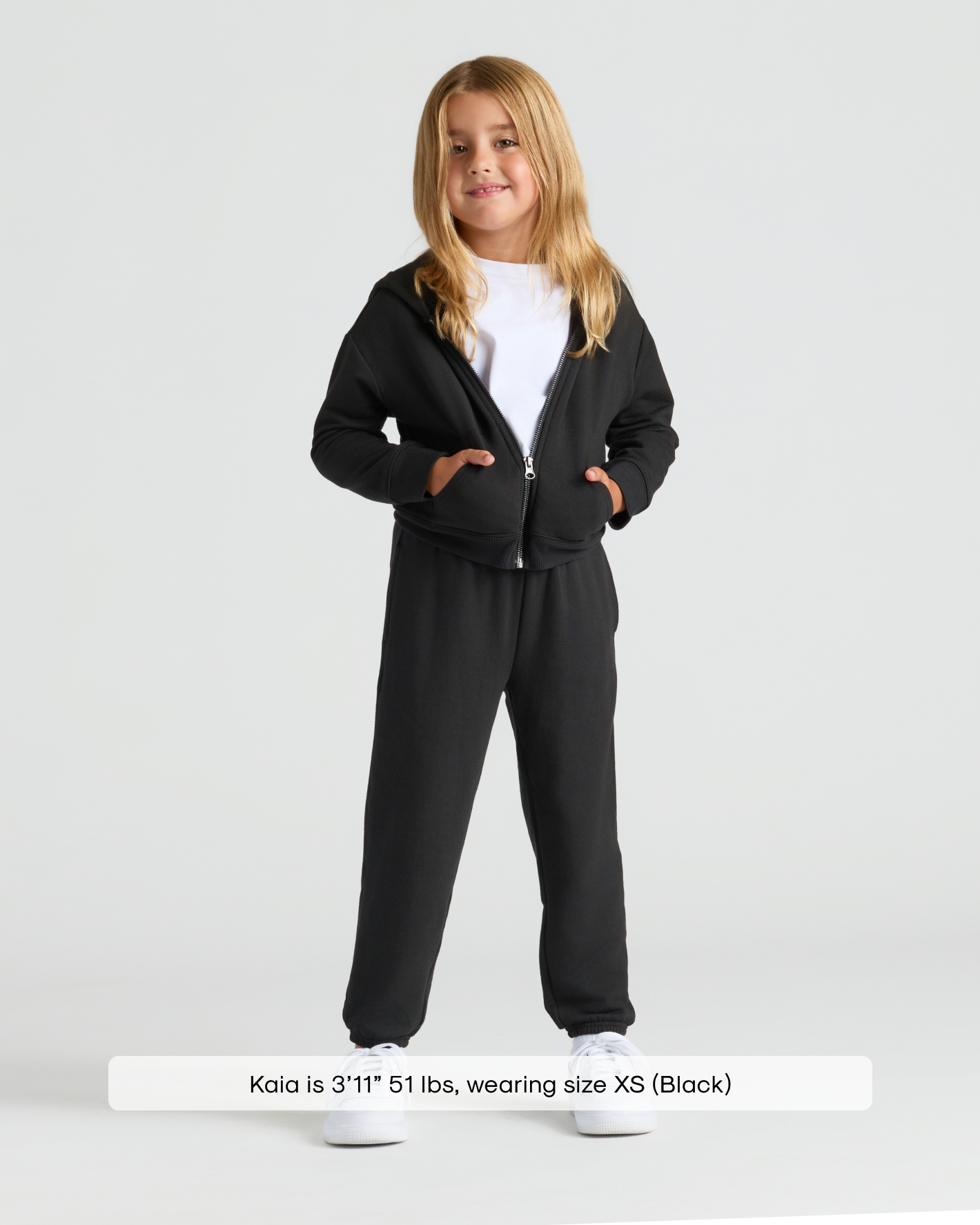 Child in Girls Black Cropped Zip Hoodie & Relaxed Joggers.