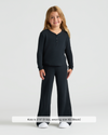 Child modeling Girls Black Waffle Long Sleeve Henley & Waffle Leg Pants.