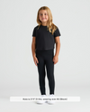 Girl in black cropped tee, wearing Girls Black Foldover Leggings.