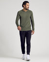 Man wearing Kelp Long Sleeve Active Mesh Crew and black joggers.