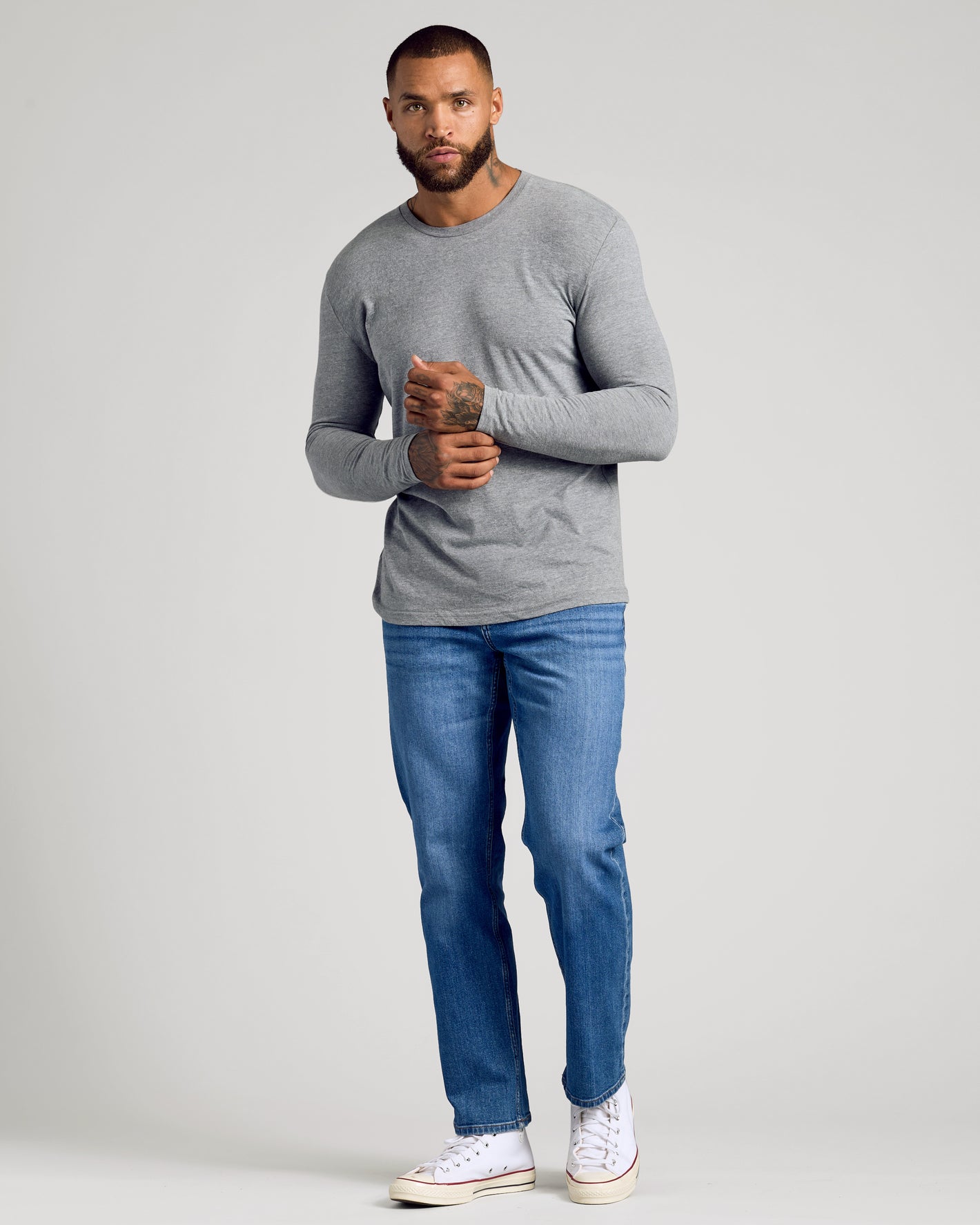 Man wearing Classic Long Sleeve 3-Pack in heather-gray with jeans and sneakers.