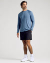 Man modeling Fiord Long Sleeve Active Mesh Crew with athletic shorts.