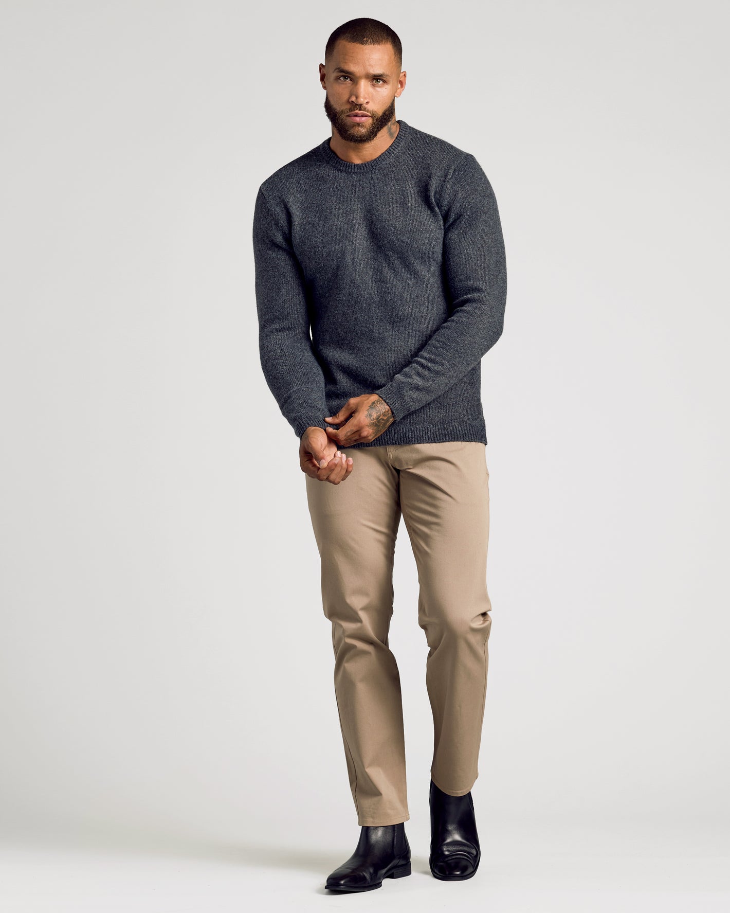 Charcoal Heather Gray Marled Crew Neck Sweater on model adjusting cuff.