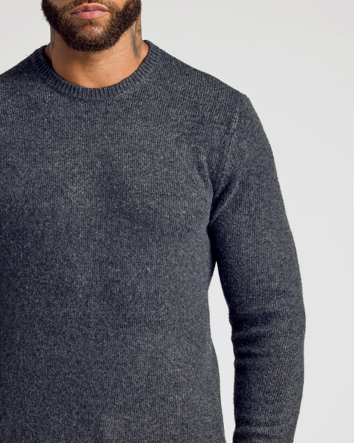 Charcoal Heather Gray Marled Crew Neck Sweater on bearded man with tattoo.