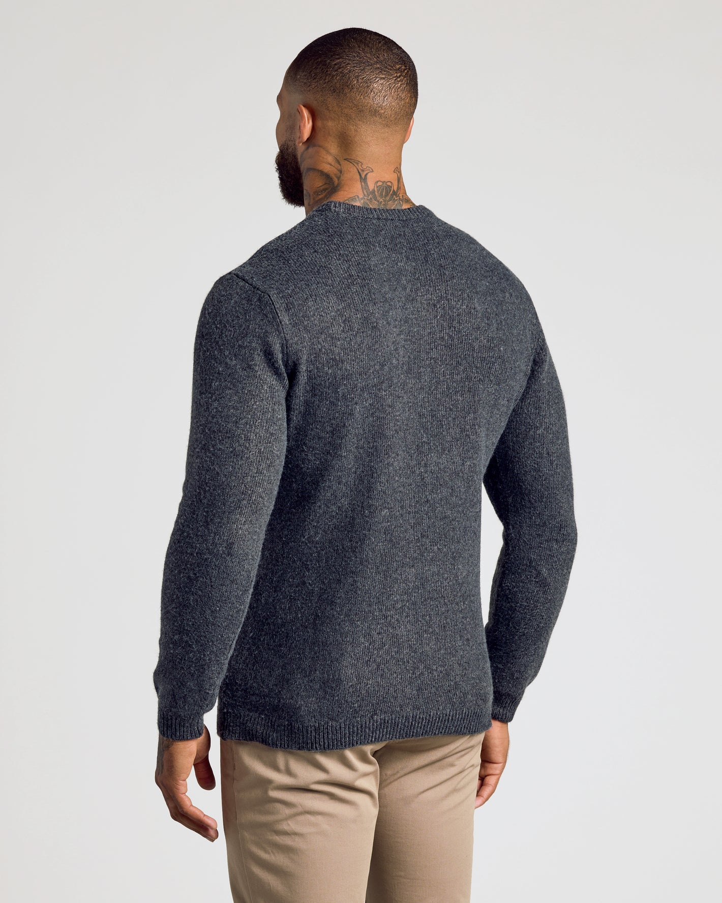 Man in Charcoal Heather Gray Marled Crew Neck Sweater, khaki trousers.