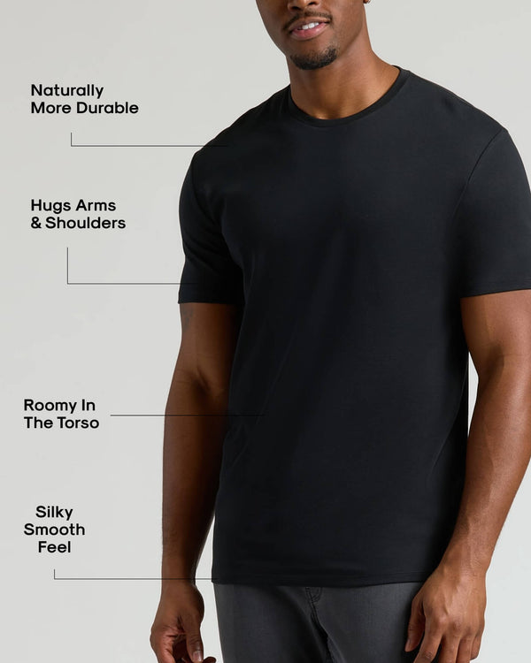 Man wearing a black Tall Pima Cotton Blend Crew 4-Pack t-shirt showcasing a durable, smooth, and roomy fit that hugs the arms and shoulders comfortably.