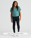 Child wearing Girls Black Foldover Leggings, teal T-shirt, and white sneakers.