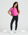 Girl in Girls Black Foldover Leggings, smiling confidently with hands on hips.