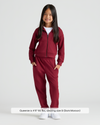 Young girl in Girls Dark Maroon Cropped Zip Hoodie & Relaxed Joggers.